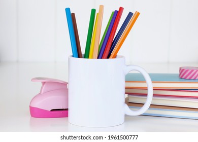 White mug mockup. Blank mug. Coffee mug mockup with colored pencils ,staple and notebooks. 11 oz - Powered by Shutterstock