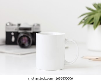 White mug mockup with vintage camera and succulent - Powered by Shutterstock