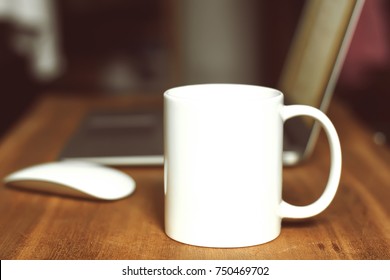 White mug on the desktop - Shutterstock ID 750469702