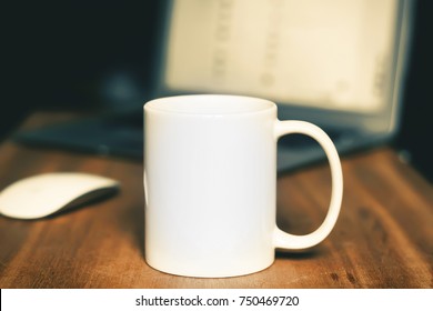 White mug on the desktop - Shutterstock ID 750469720