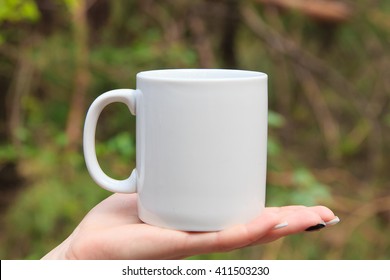 White Mug On Hand For Mockup