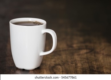 White Mug On Wooden Brown Table.