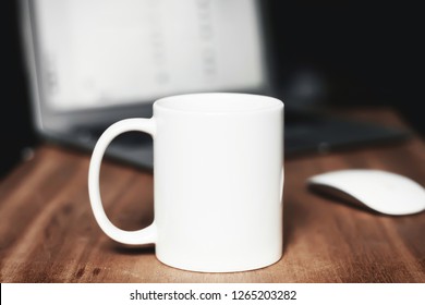 White mug on the wooden table. Office background - Shutterstock ID 1265203282
