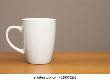 White mug on wooden table
