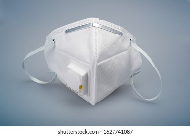 White n95 mask on blue background, n95 respirator with ventilation valve, anti-haze mask,