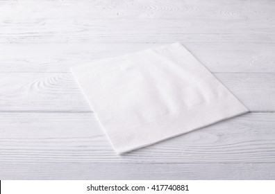 White napkin on a wooden table. Top view. - Shutterstock ID 417740881
