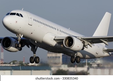 White Narrow Body Airplane Shortly After Take-off