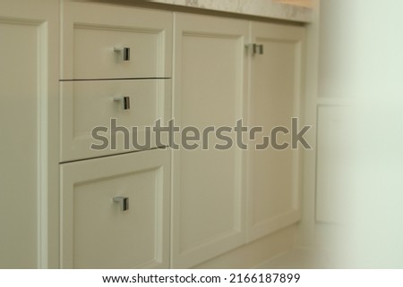 White or natural beige drawer and shelves for storing various miscellaneous items in the modern house living apartment. Close up cabinet built in and free space for wallpaper background cover page.