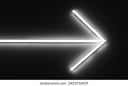 White neon light arrow sign background.