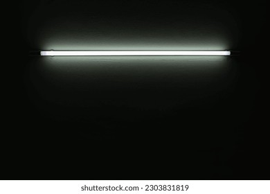 White neon light bulb on white wall.