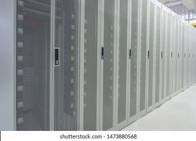 White Network Cabinets Neatly Arranged In The Data Center Room