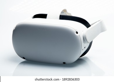 White new generation VR headset isolated on white background  with sparkling futuristic lights. Oculus Quest 2 virtual reality headset Amsterdam, the Netherlands 2021.01.01  