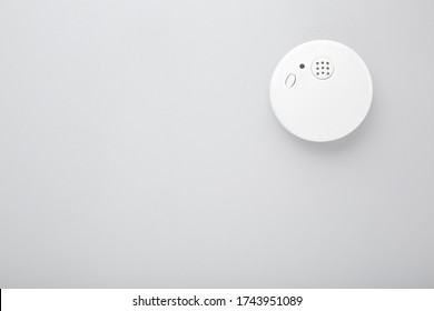 White New Smoke Alarm On Light Gray Background. Safety Concept. Empty Place For Text.