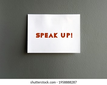 White Note On Gray Cement Wall With Text SPEAK UP !, Self Reminder To Raise Voice Louder Or Dare To Express Opinion Frankly And Openly , Stand Up For Yourself