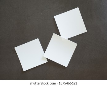White note paper placed on black cement floor - Shutterstock ID 1375466621