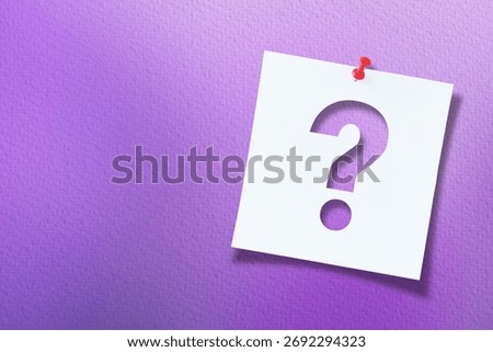 White note paper with question mark and red push pin on textured purple  background