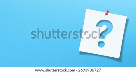 White note paper with question mark and red push pin on blue background