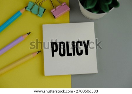 white notebook with the word policy. basic concepts or organizational policies
