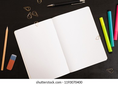 White notepad on black table