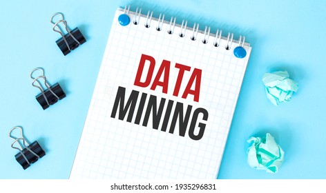 White Notepad With Text DATA MINING And Office Tools On The Blue Background