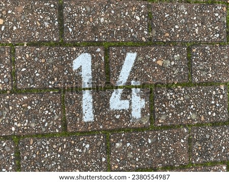 white number 14 on asphalt