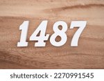 White number 1487 on a brown and light brown wooden background.