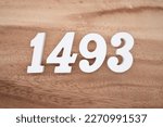 White number 1493 on a brown and light brown wooden background.