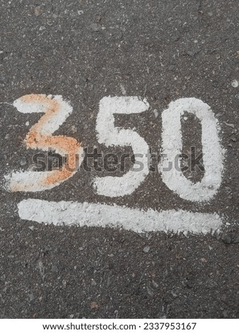 white number 350 on the asphalt textur 