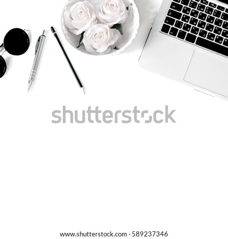 White office desk frame with laptop keyboard and supplies. Laptop, notebook, pen, clips, pencil, roses and office supplies on white background. Flat lay, top view, mockup