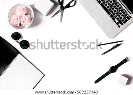 White office desk frame with laptop keyboard and supplies. Laptop, notebook, pen, roses, sunglasses, pencil, scissors, watch and office supplies on white background. Flat lay, top view, mockup