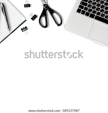 White office desk frame with laptop keyboard and supplies. Laptop, notebook, pen, clips, pencil and office supplies on white background. Flat lay, top view, mockup