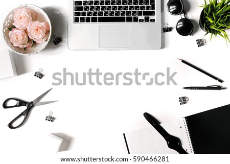 White office desk frame with laptop keyboard and supplies. Laptop, notebook, pen, roses, sunglasses, clips, plant, scissors, watch and office supplies on white background. Flat lay, top view, mockup