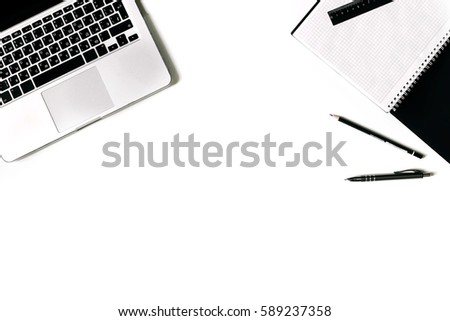 White office desk frame with paper blank and supplies. Laptop, notebook, pen, clips, glasses and office supplies on white background. Flat lay, top view, mockup.