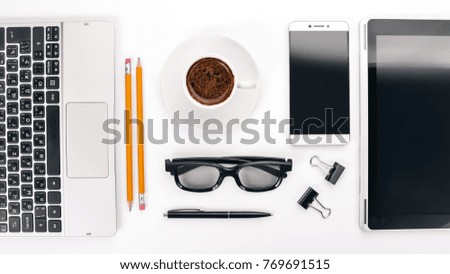 Business objects, cup of coffee, pen, phone and glasses.