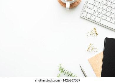 White office desk table with computer tools, notebook, and supplies. Top view with copy space, flat lay. - Shutterstock ID 1426267589