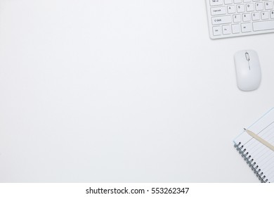 White office desk table with computer Keyboard ,notebook,mouse and pencil ,Top view with copy space for your text