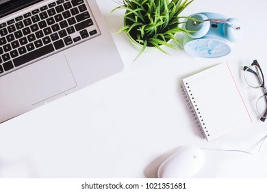 White office desk table with computer,note book,pen and spectacle.View from top with copy space.Flat Lay. - Shutterstock ID 1021351681