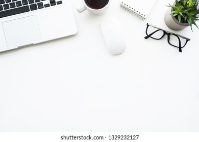 White office desk table with laptop computer and lop of supplies on it. Top view with copy space, flat lay. - Shutterstock ID 1329232127