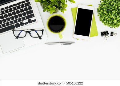 White office desk table with laptop, coffee, supplies and plants. Top view with copy space, flat lay. - Powered by Shutterstock