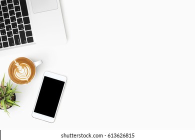 White Office Desk Table With Smartphone, Laptop Computer And Cup Of Coffee. Top View With Copy Space, Flat Lay.