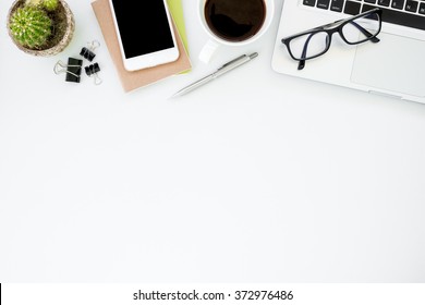 White office desk table with a lot of things on it. Top view with copy space.
 - Shutterstock ID 372976486