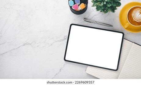 White office desk workplace with blank screen tablet, pen, notebook and cup of coffee, Top view flat lay with copy space. - Shutterstock ID 2269609357