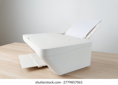 White office printer with a stack of blank A4 paper loaded in the feeder tray, shown in a clean minimalist workspace. Conceptual image for printing, office equipment, productivity and documentation.