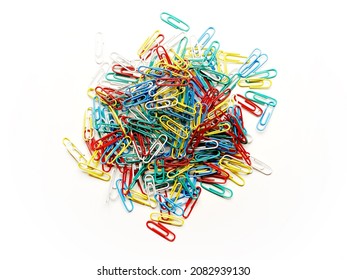 a white office space with brightly lite colorful paperclips in a round pile shape