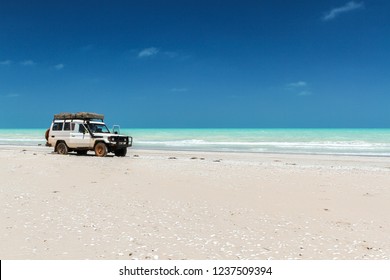 White Off-road Car On Beautiful Sunny Beach. Summer Journey And Stopover On The Beach. Eighty Mile Beach.
Western Australia. Australia