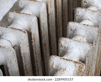 White old cast iron batteries close up. Old cast iron central heating battery. Scrap metal and recyclables. Delivery of scrap metal, replacement of the heating system in the apartment. - Powered by Shutterstock