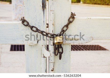 White Old gate locked with a chain, vintage background