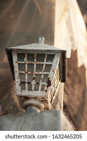 white old and rusty lantern light lamp on old wall
