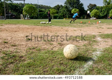 white old soccer ball on soccer field,that boys are practicing soccer
