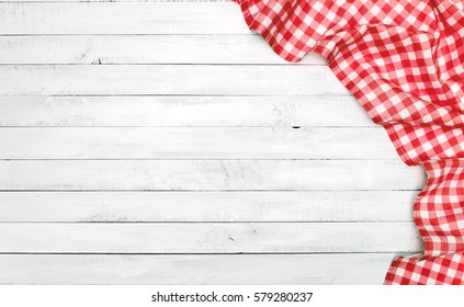 White old vintage wooden table with a red checkered tablecloth.  - Shutterstock ID 579280237
